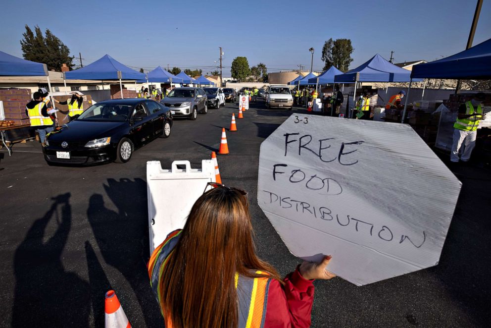 PHOTO: Cars line-up as the Los Angeles Regional Food Bank distributes food outside a church during the outbreak of the coronavirus disease (COVID-19) in Los Angeles, Nov. 19, 2020.