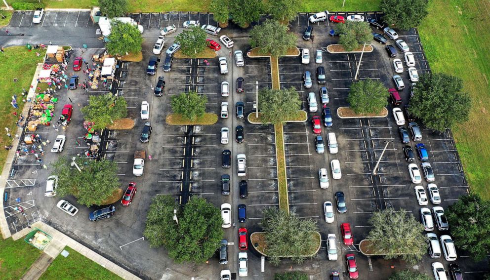 PHOTO: Residents line up in their cars at a food distribution site at Lake-Sumter State College sponsored by the Second Harvest Food Bank of Central Florida and local churches in Clermont, Fla., Nov. 11, 2020. 