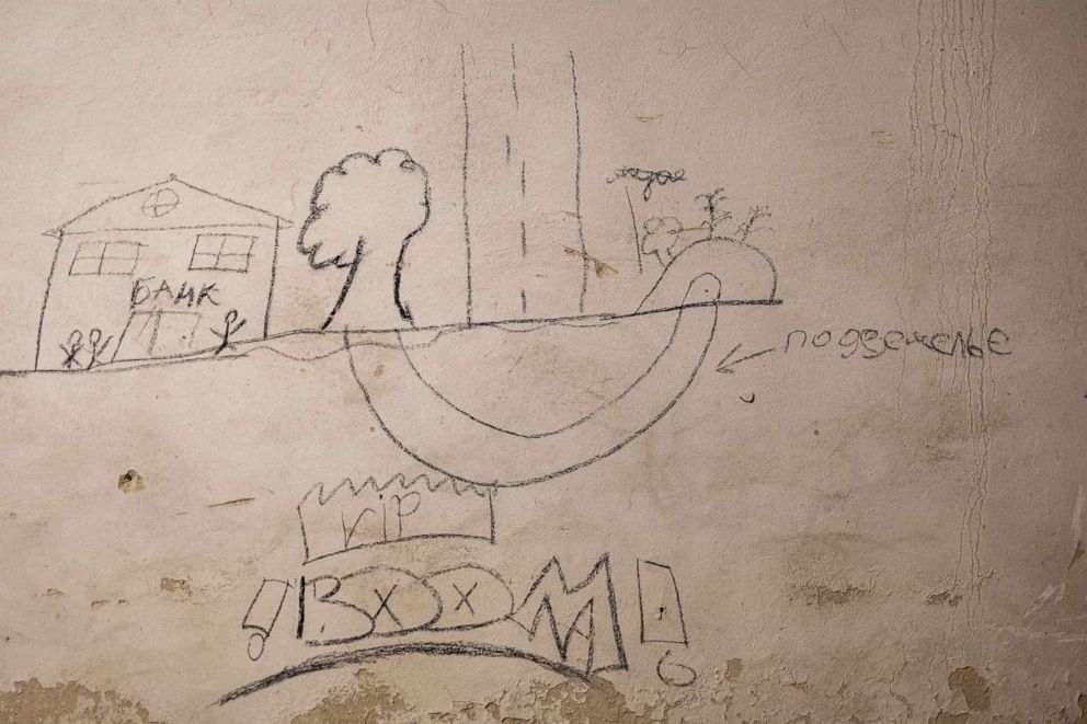 PHOTO: A drawing is seen on a wall inside the basement of the school, with the words "Underground, bank and boom."