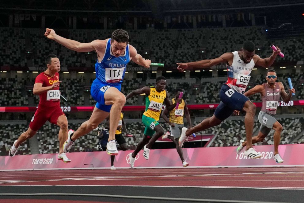 PHOTO: Filippo Tortu, of Italy, crosses the finish line ahead of Nethaneel Mitchell-Blake, of Britain, to lead his to team a gold medal in the men's 4x100-meter relay at the 2020 Summer Olympics, Aug. 6, 2021, in Tokyo.