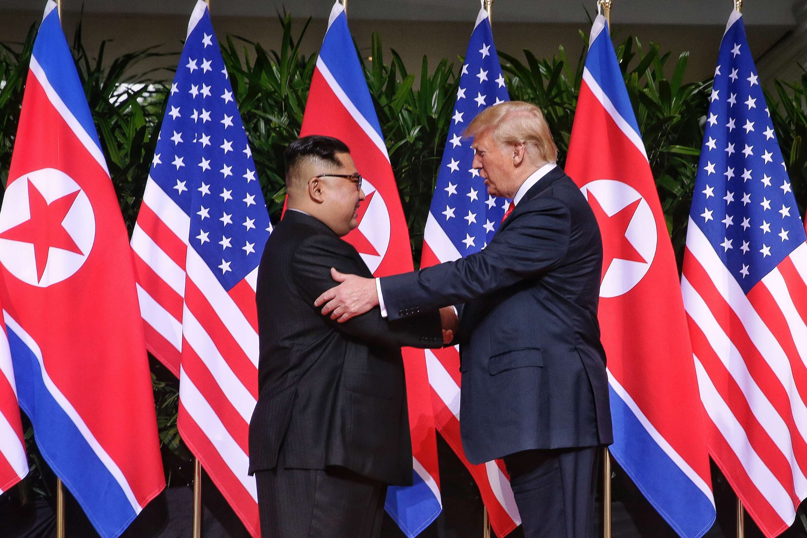 PHOTO: North Korean leader Kim Jong-un shakes hands with President Donald Trump during their historic U.S.-DPRK summit at the Capella Hotel on Sentosa island on June 12, 2018 in Singapore.