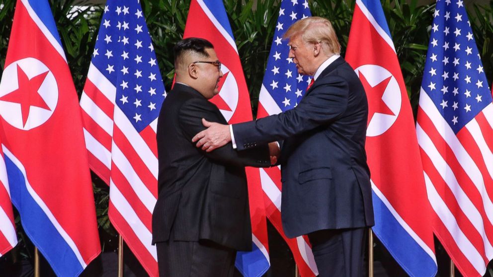 PHOTO: North Korean leader Kim Jong-un shakes hands with President Donald Trump during their historic U.S.-DPRK summit at the Capella Hotel on Sentosa island on June 12, 2018 in Singapore.