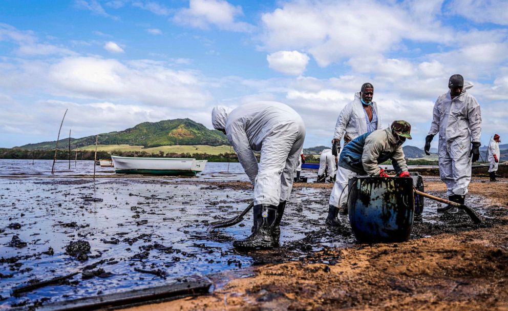 PHOTO: People scoop leaked oil from the MV Wakashio in southeast Mauritius, Aug. 9, 2020.