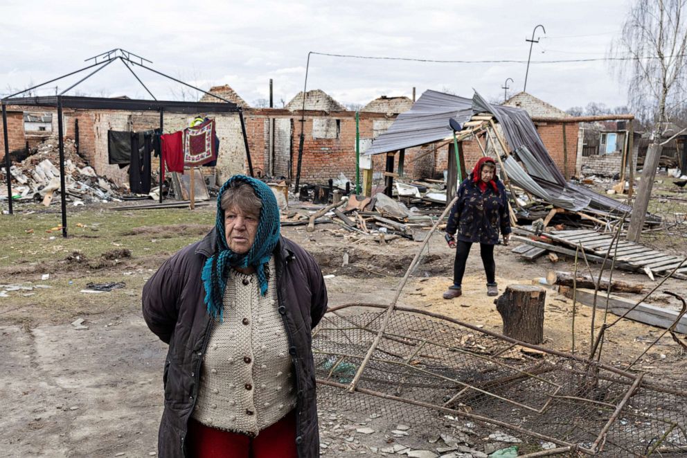 PHOTO: Hanna Khlystun stands amongst destroyed houses in Yahidne. 