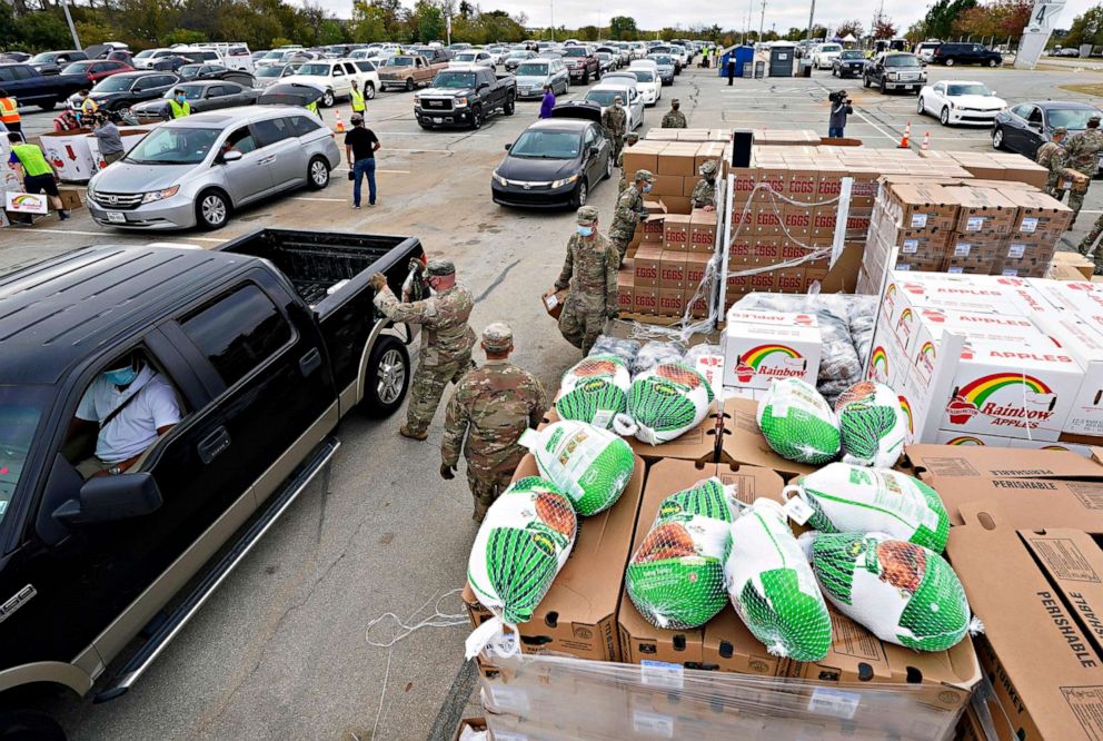 PHOTO: Soldier from the U.S. Army 36th Infantry Division help distribute turkeys and other holiday food items during a Tarrant Area Food Bank mobile pantry event in Arlington, Texas, Nov. 20, 2020.