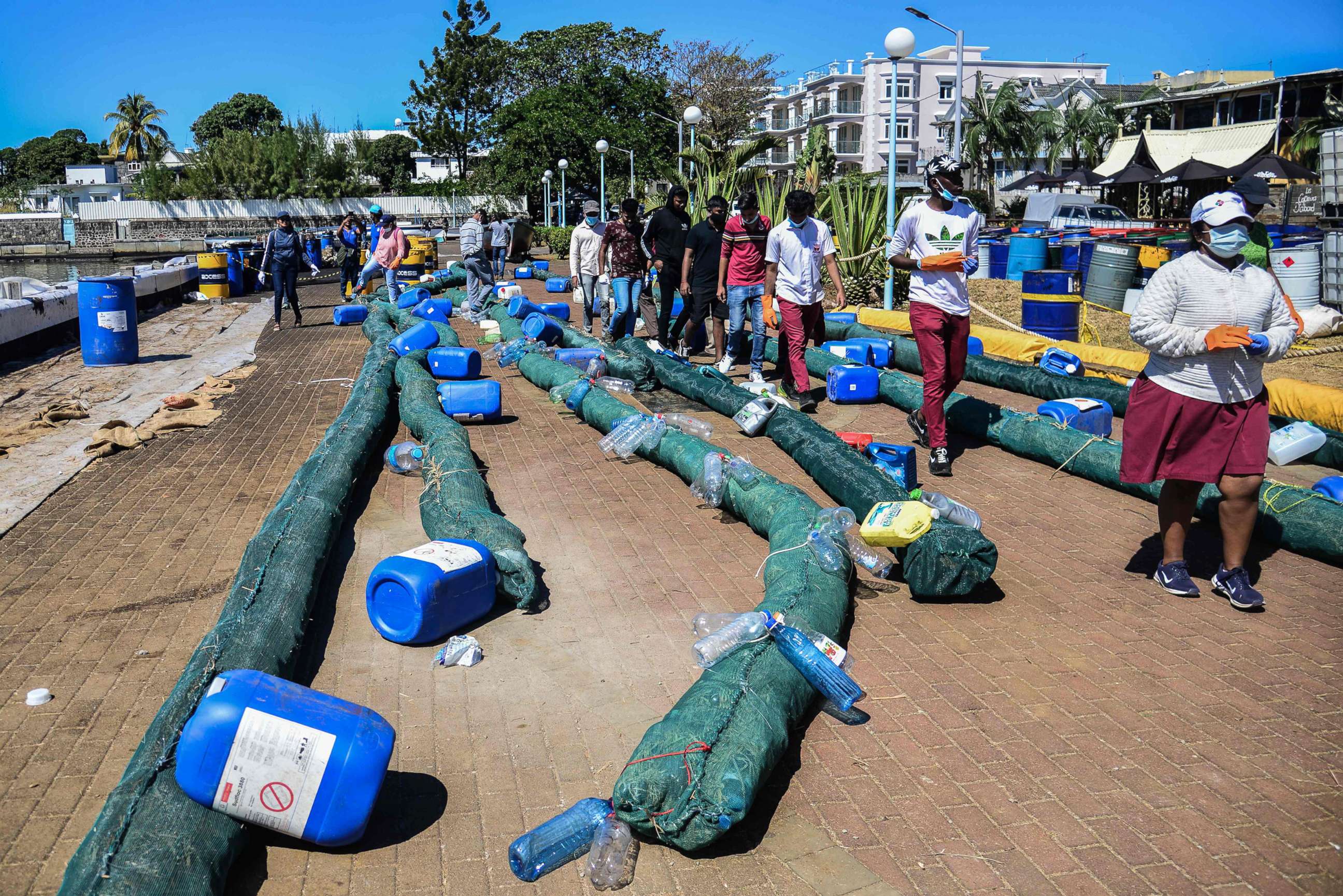 PHOTO: Volunteers make oil barriers to absorb leaked oil from the MV Wakashio bulk carrier that had run aground off Mahebourg, Mauritius, Aug. 14, 2020.