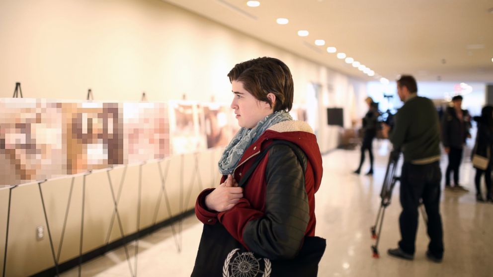 PHOTO: A viewer looks on at the "Caesar" photo exhibition at the United Nations Headquarters in New York, March 13, 2015.