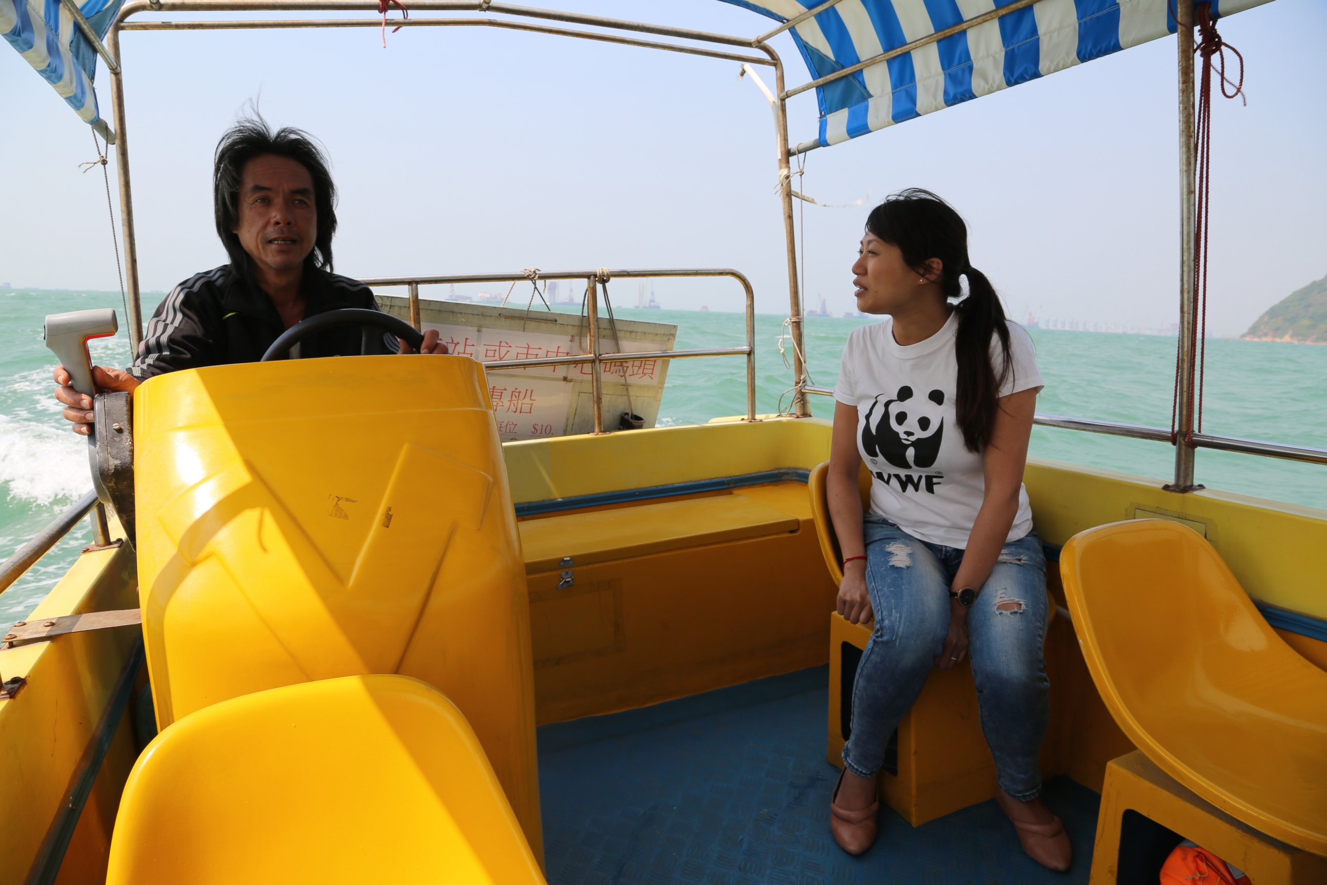 PHOTO: Samantha Lee and local dolphin watching operator scouting the waters for dolphins.