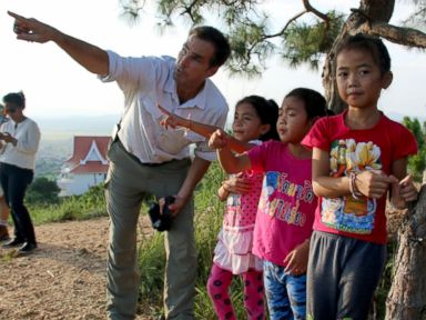 PHOTO: ABCs Bob Woodruff talks with children in Laos.