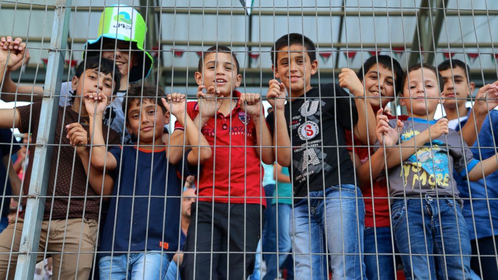 Young football fans in the stands at the Palestine Cup final match.