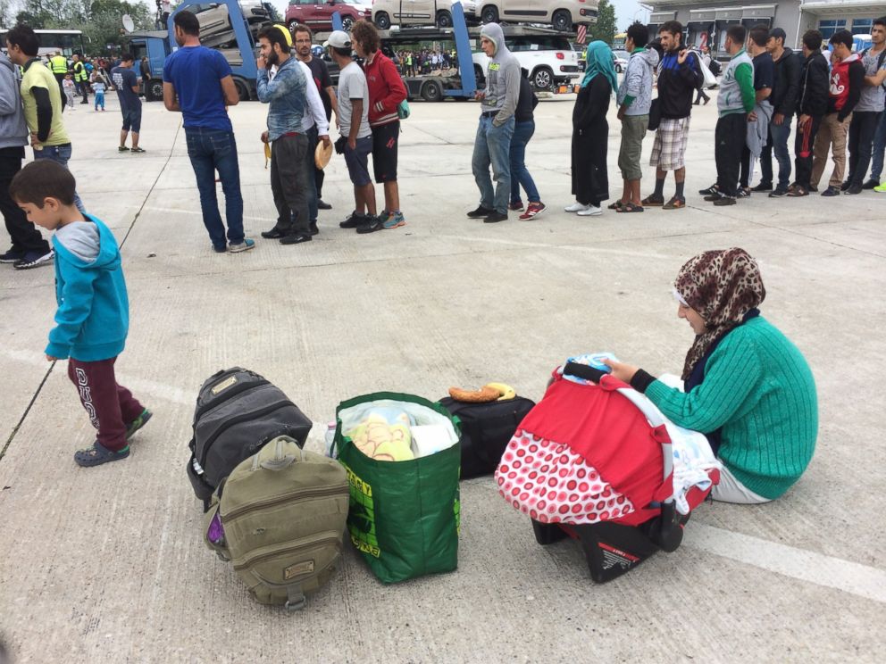 PHOTO: A boy gives diapers to a Syrian woman in the small Austrian village of Nikhelsdorf.