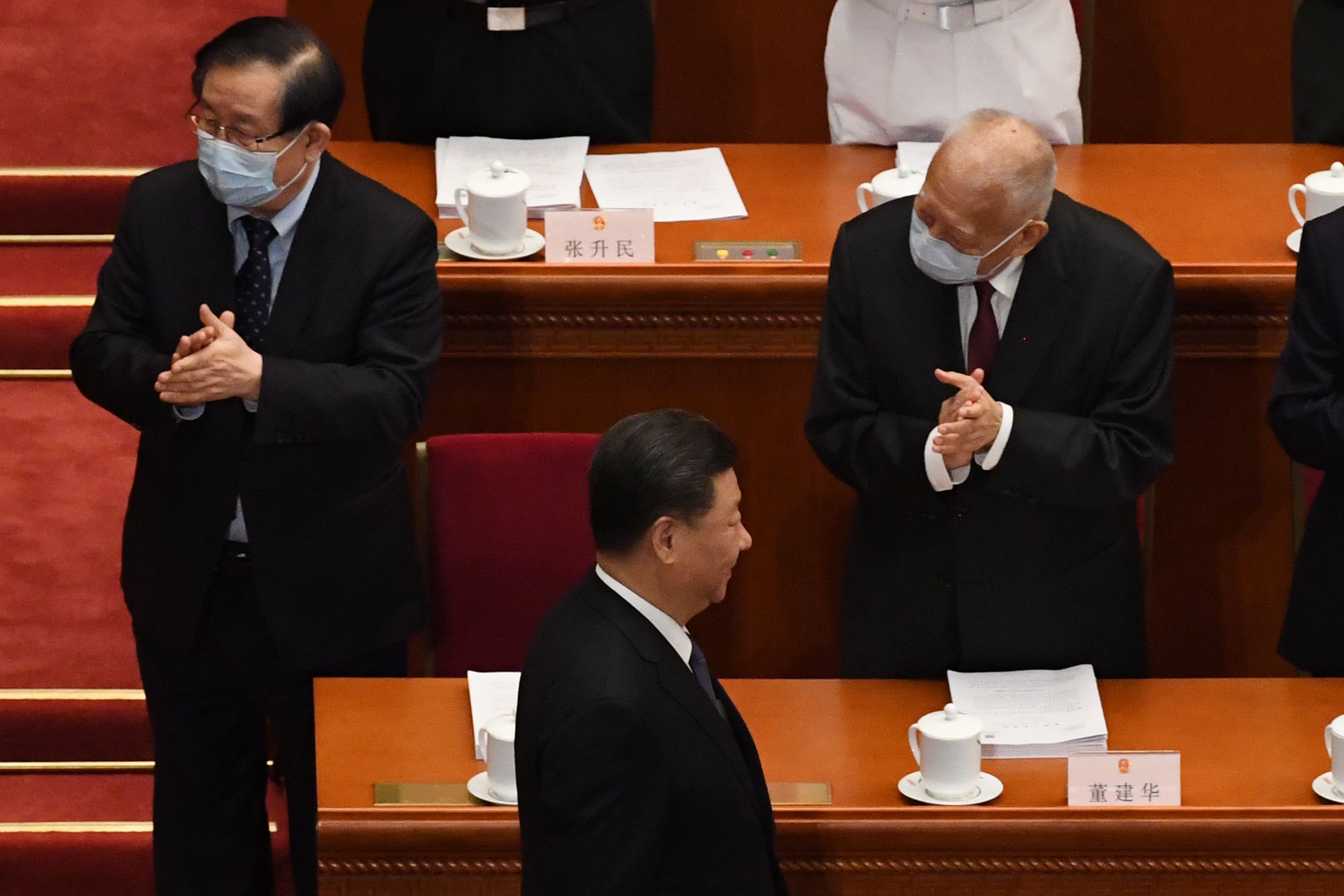 PHOTO: Chinese President Xi Jinping (C) walks past former Hong Kong chief executive Tung Chee-hwa (R) as he arrives for the opening session of the National People's Congress (NPC) at the Great Hall of the People in Beijing on May 22, 2020.