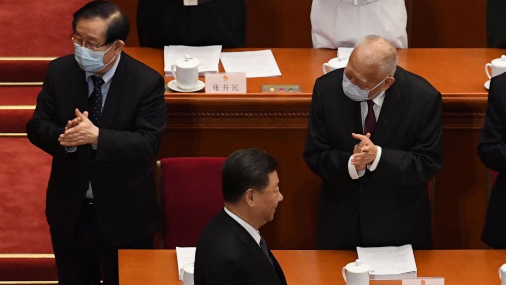 PHOTO: Chinese President Xi Jinping (C) walks past former Hong Kong chief executive Tung Chee-hwa (R) as he arrives for the opening session of the National People's Congress (NPC) at the Great Hall of the People in Beijing on May 22, 2020.
