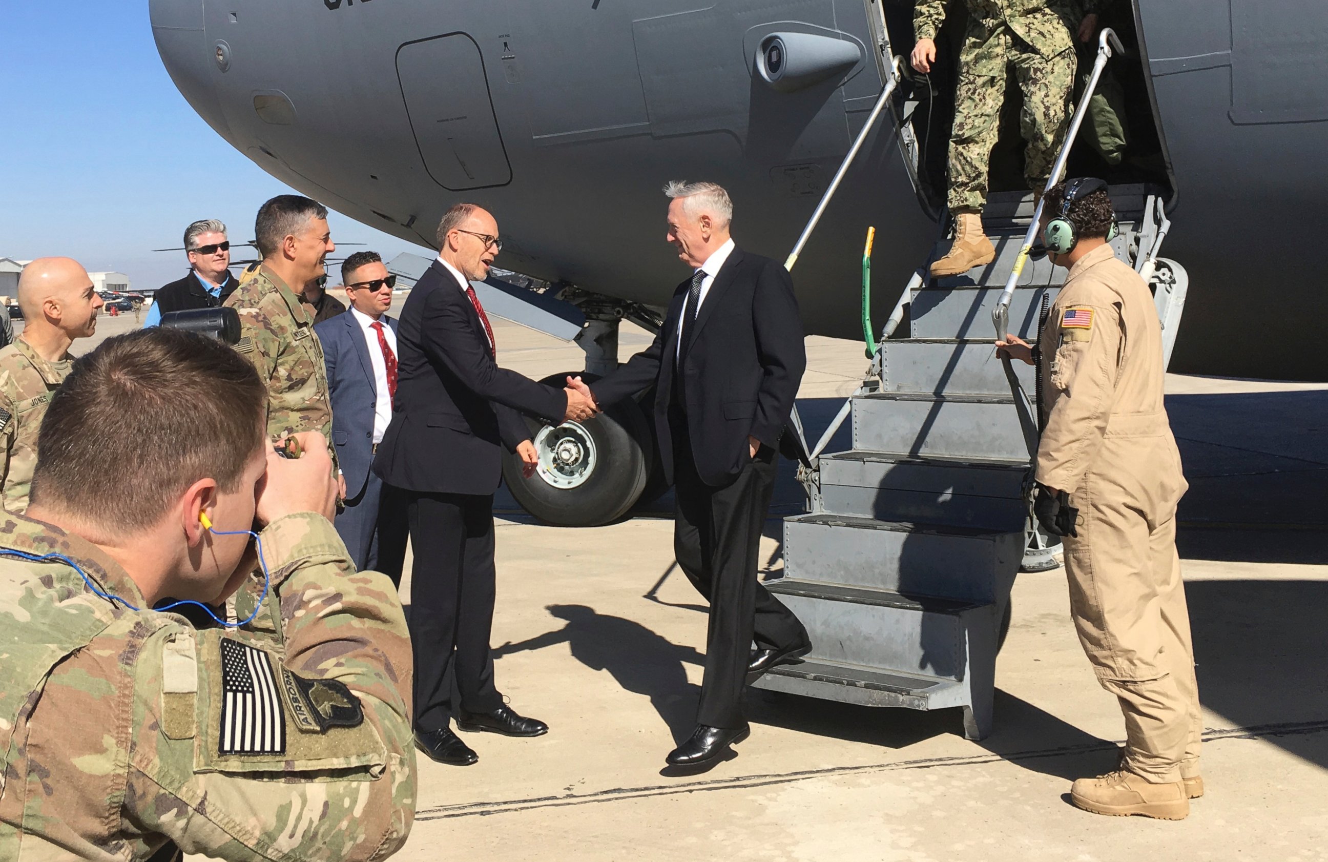 PHOTO: U.S. Sec. of Defense Jim Mattis, center, is greeted by U.S. Ambassador Douglas Silliman as he arrives at Baghdad International Airport on an unannounced trip Monday, Feb. 20, 2017. 