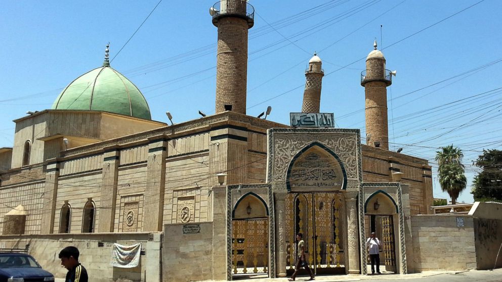 PHOTO: People walk in front of the Great Mosque of al-Nuri in Mosul, Iraq in this July 21, 2014 file photo.