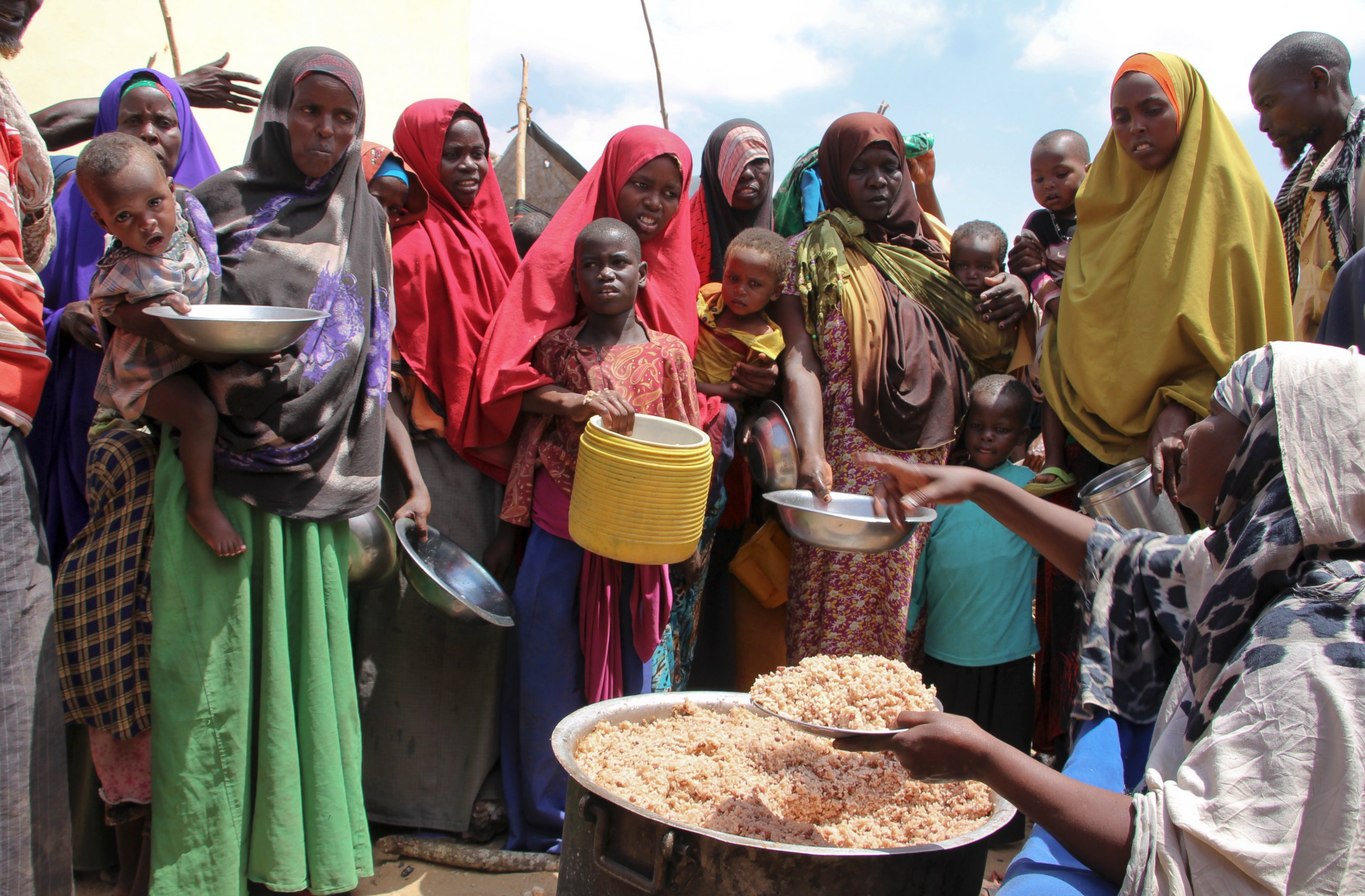 PHOTO: Newly arrived Somalis, displaced by the drought, receive food distributions at makeshift camps in the Tabelaha area on the outskirts of Mogadishu, Somalia, on March 30, 2017. 