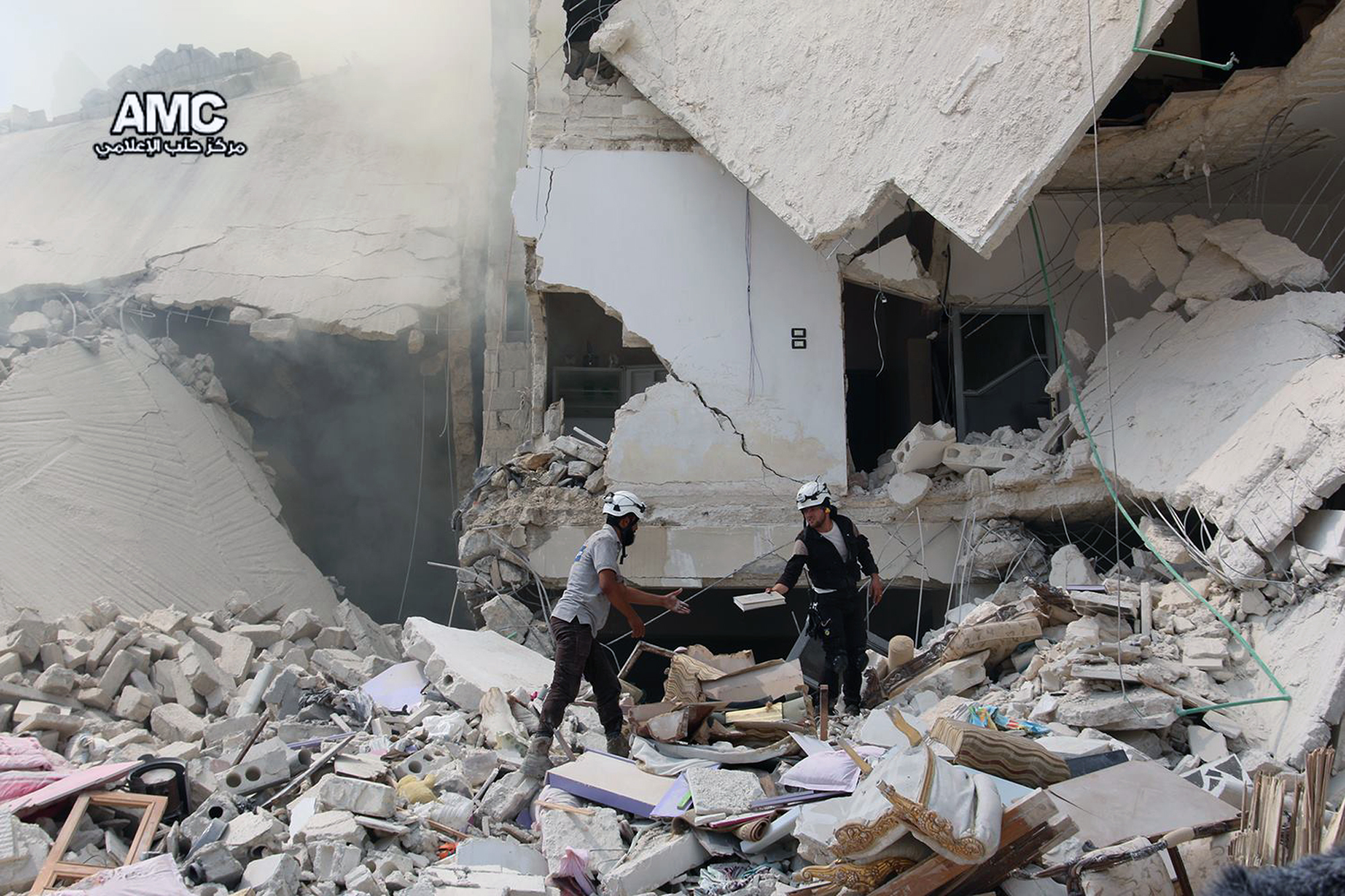 PHOTO: Syrian civil defense workers inspecting damaged buildings, after barrel bombs were dropped on the Bab al-Nairab neighborhood in Aleppo, Syria, Aug. 27, 2016. 