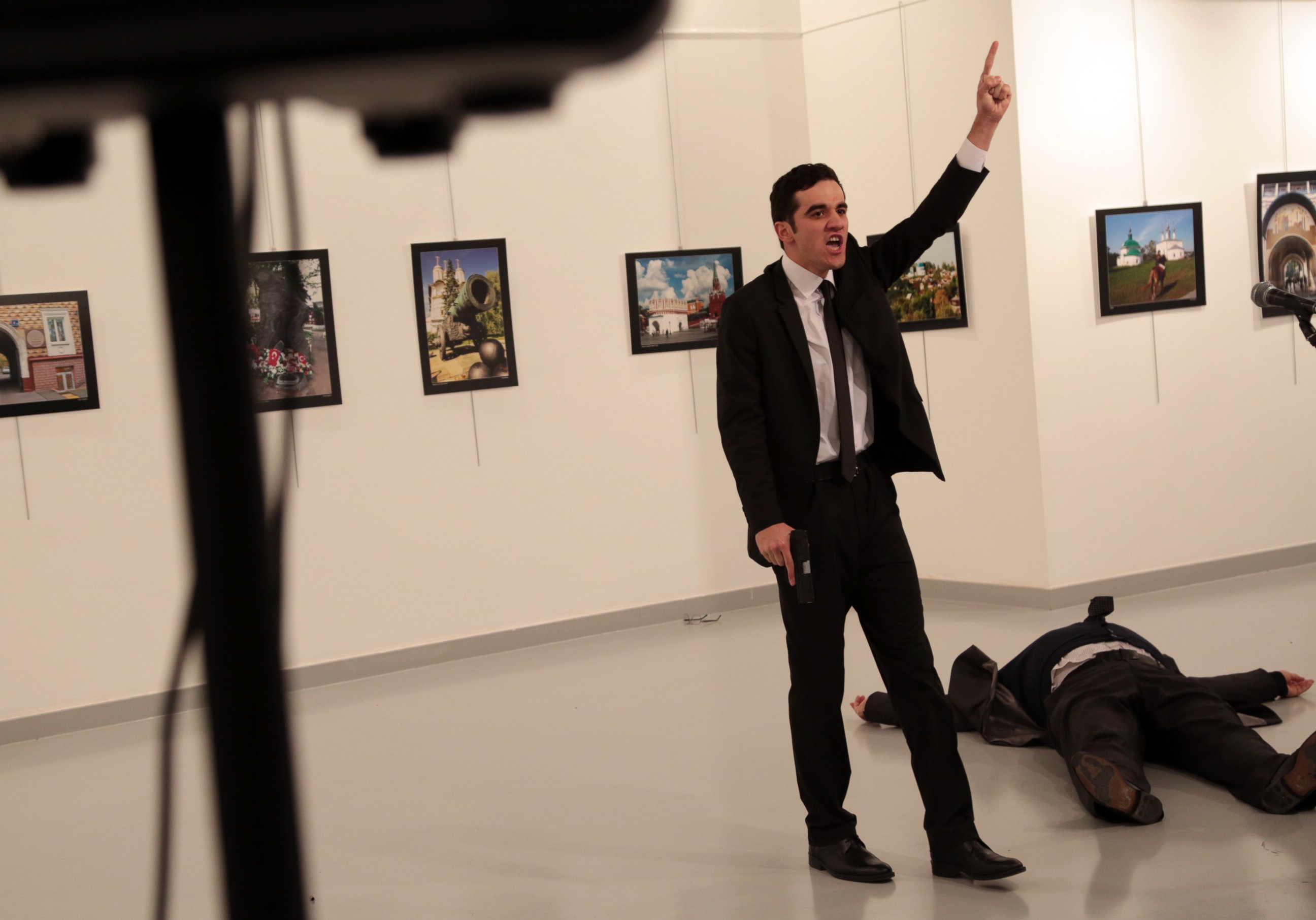 PHOTO: A man identified as Mevlut Mert Altintas  gestures near to the body of a man at a photo gallery in Ankara, Turkey, Dec. 19, 2016. An Associated Press photographer says a gunman has fired shots at the Russian ambassador to Turkey. 