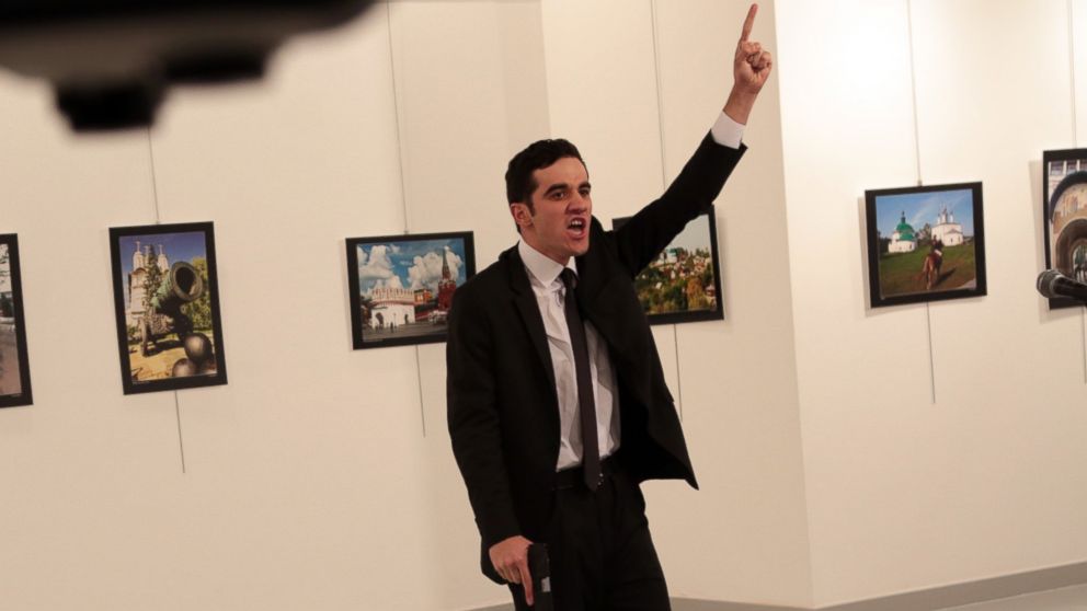 PHOTO: A man identified as Mevlut Mert Altintas  gestures near to the body of a man at a photo gallery in Ankara, Turkey, Dec. 19, 2016. An Associated Press photographer says a gunman has fired shots at the Russian ambassador to Turkey. 