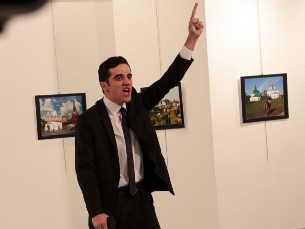 PHOTO: A man identified as Mevlut Mert Altintas gestures near to the body of a man at a photo gallery in Ankara, Turkey, Dec. 19, 2016. An Associated Press photographer says a gunman has fired shots at the Russian ambassador to Turkey.