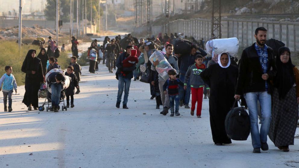 This Sunday, Nov. 27, 2016 photo provided by the Rumaf, a Syrian Kurdish activist group, which has been authenticated based on its contents and other AP reporting, shows people fleeing rebel-held eastern neighborhoods of Aleppo into the Sheikh Maqsoud area that is controlled by Kurdish fighters, Syria.