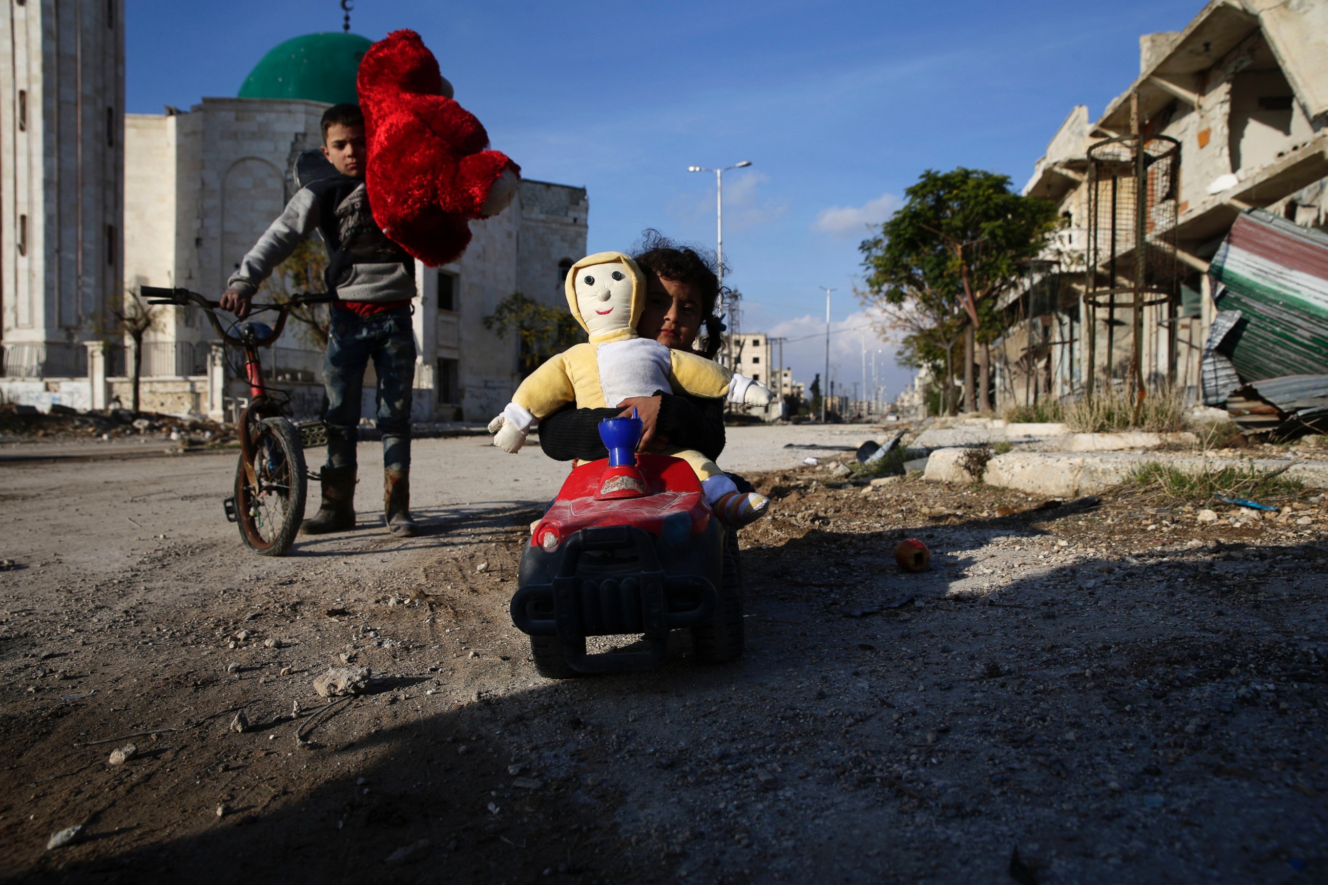 PHOTO: Syrian children, who were displaced from east Aleppo last month with their families, play with toys as they return to their home in the Hanano district of eastern Aleppo, Syria, Dec. 4, 2016. 