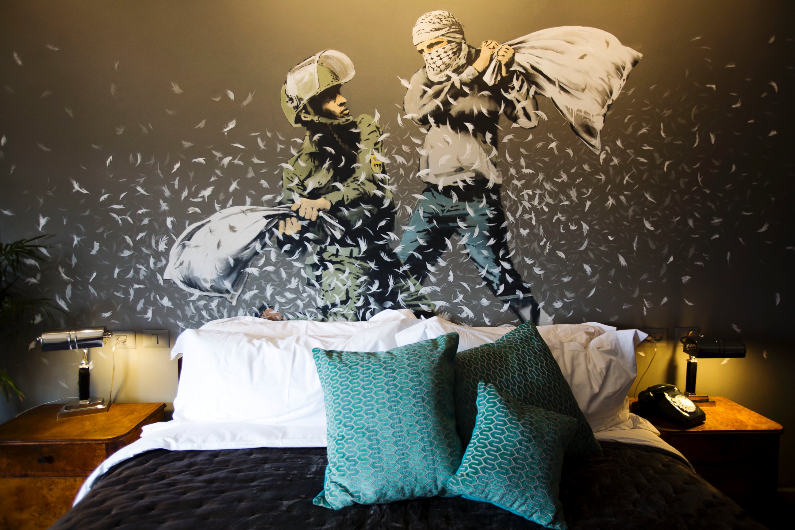 PHOTO: A Banksy wall painting showing Israeli border policeman and Palestinian in a pillow fight is seen in one of the rooms of the "The Walled Off Hotel" in the West Bank city of Bethlehem, March 3, 2017.