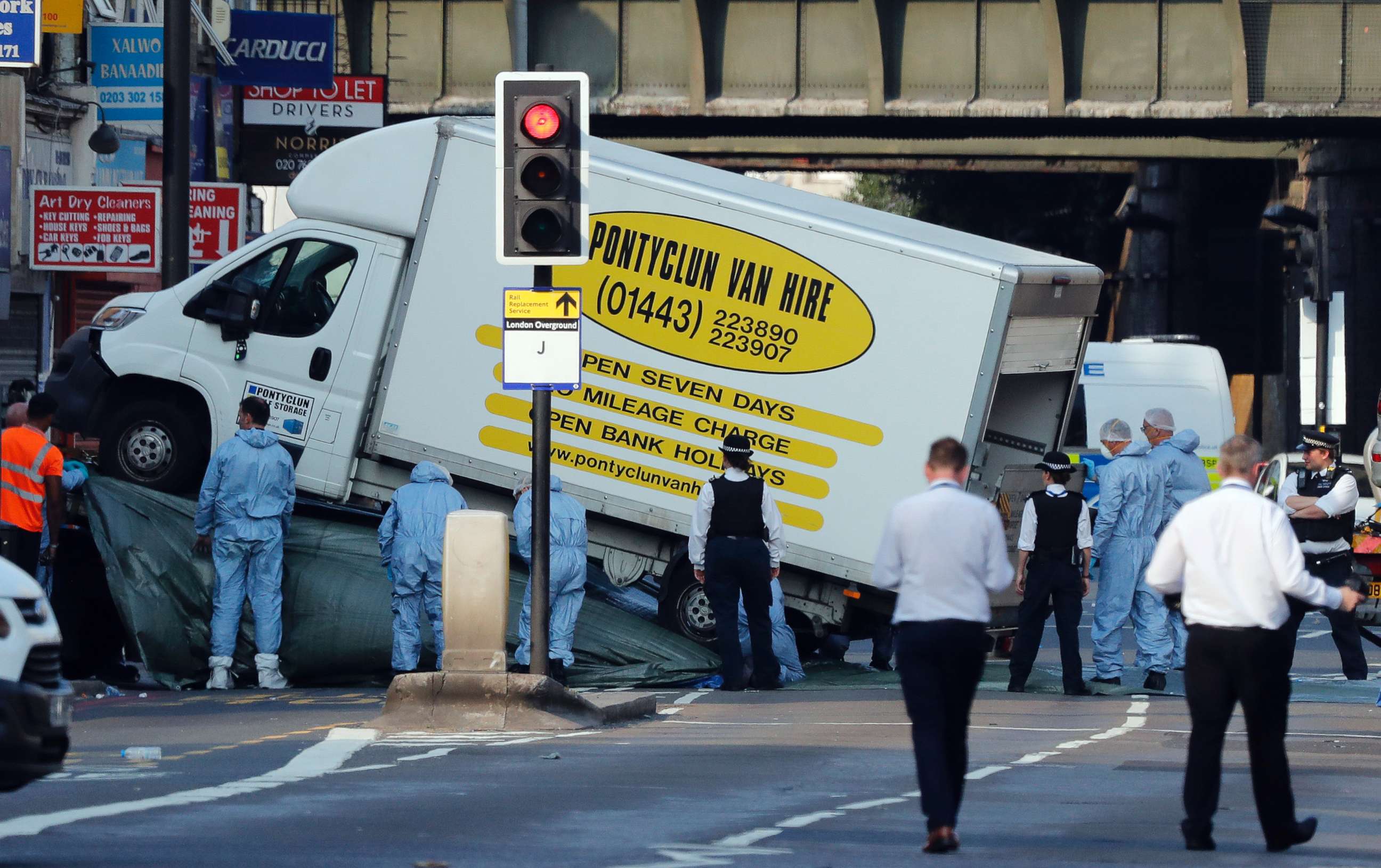 PHOTO: Forensic officers move the van at Finsbury Park in north London, where a vehicle struck pedestrians in north London, June 19, 2017.  