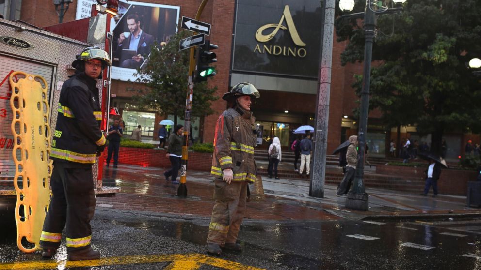 PHOTO: Firefighters stand outside the Centro Andino shopping center in Bogota, Colombia, June 17, 2017. 