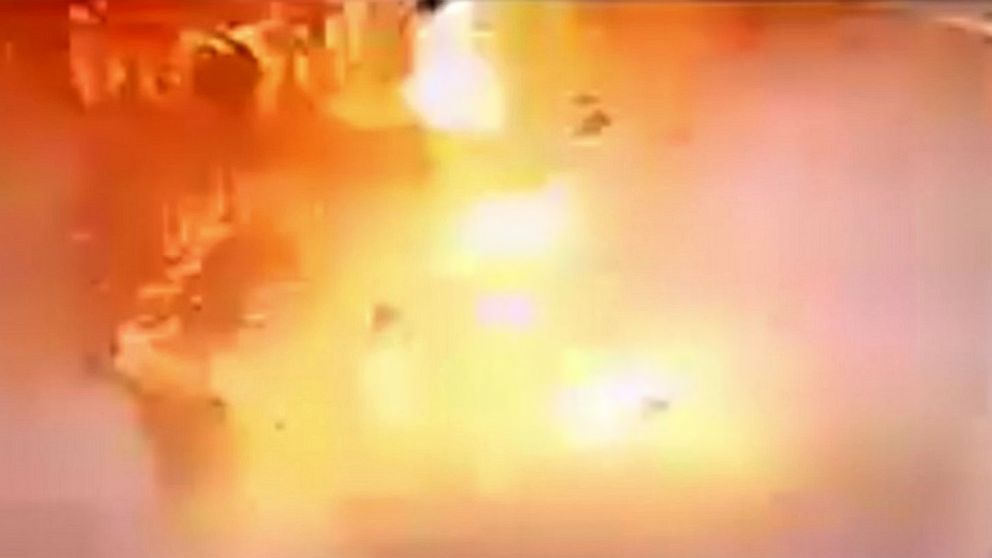PHOTO: In video made available by Egyptian Interior Ministry, a man sits at right as a suicide bomber detonates at the front gates into St. Mark's Coptic Cathedral in Alexandria, Egypt, Sunday April 9, 2017.