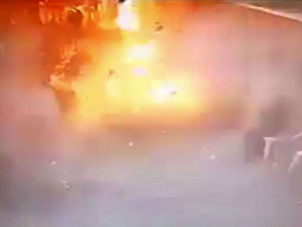 PHOTO: In video made available by Egyptian Interior Ministry, a man sits at right as a suicide bomber detonates at the front gates into St. Marks Coptic Cathedral in Alexandria, Egypt, Sunday April 9, 2017.