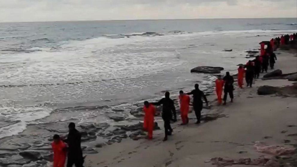 PHOTO: This file image made from a video released Feb. 15, 2015 by militants in Libya claiming loyalty to the Islamic State group purportedly shows Egyptian Coptic Christians in jumpsuits being led along a beach, each accompanied by a masked militant.