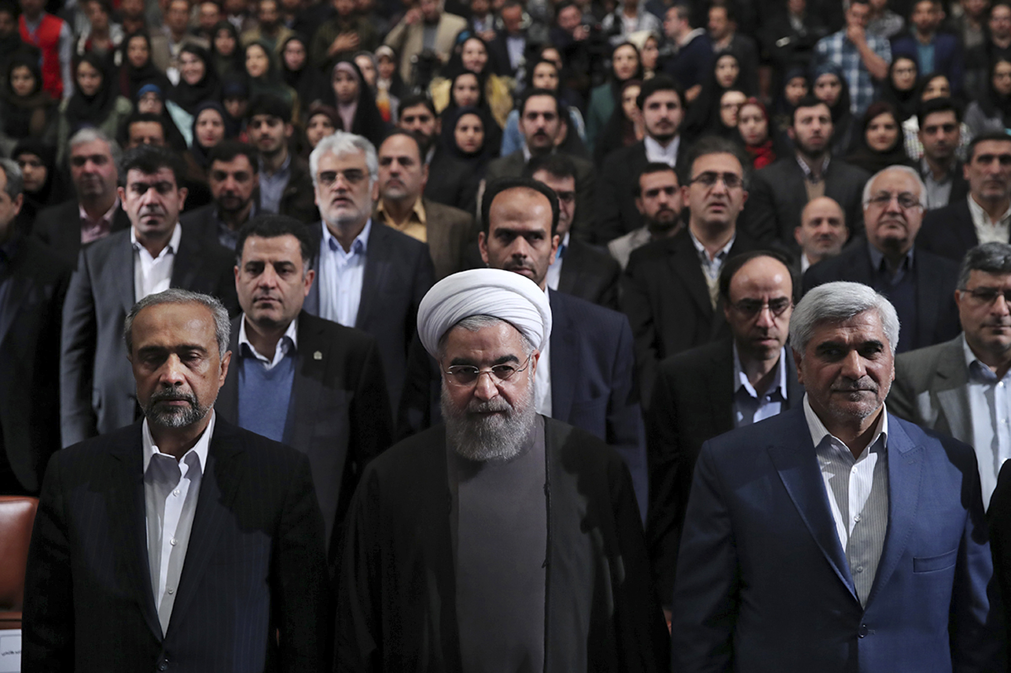 PHOTO: In this photo released by official website of the office of the Iranian Presidency, President Hassan Rouhani, center, listens to the national anthem at the start of a ceremony marking Student Day at Tehran University in Tehran, Iran, Dec. 6, 2016.