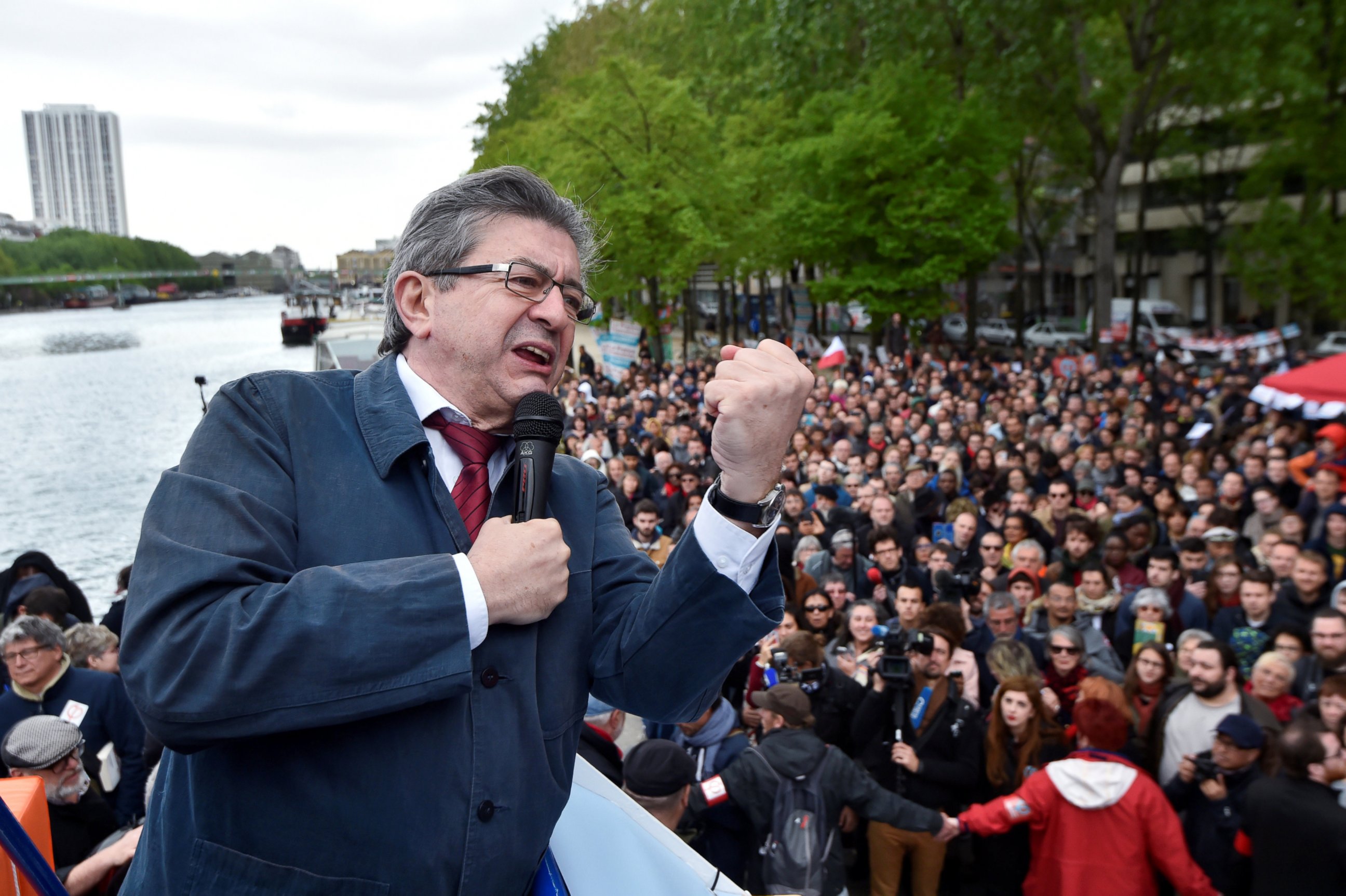 PHOTO: Jean-Luc Melenchon, candidate of the French far-left Parti de Gauche and candidate for the French 2017 presidential election, delivers a speech to supporters from a barge during a cruise on the canal de l'Ourcq in Paris, April 17, 2017.