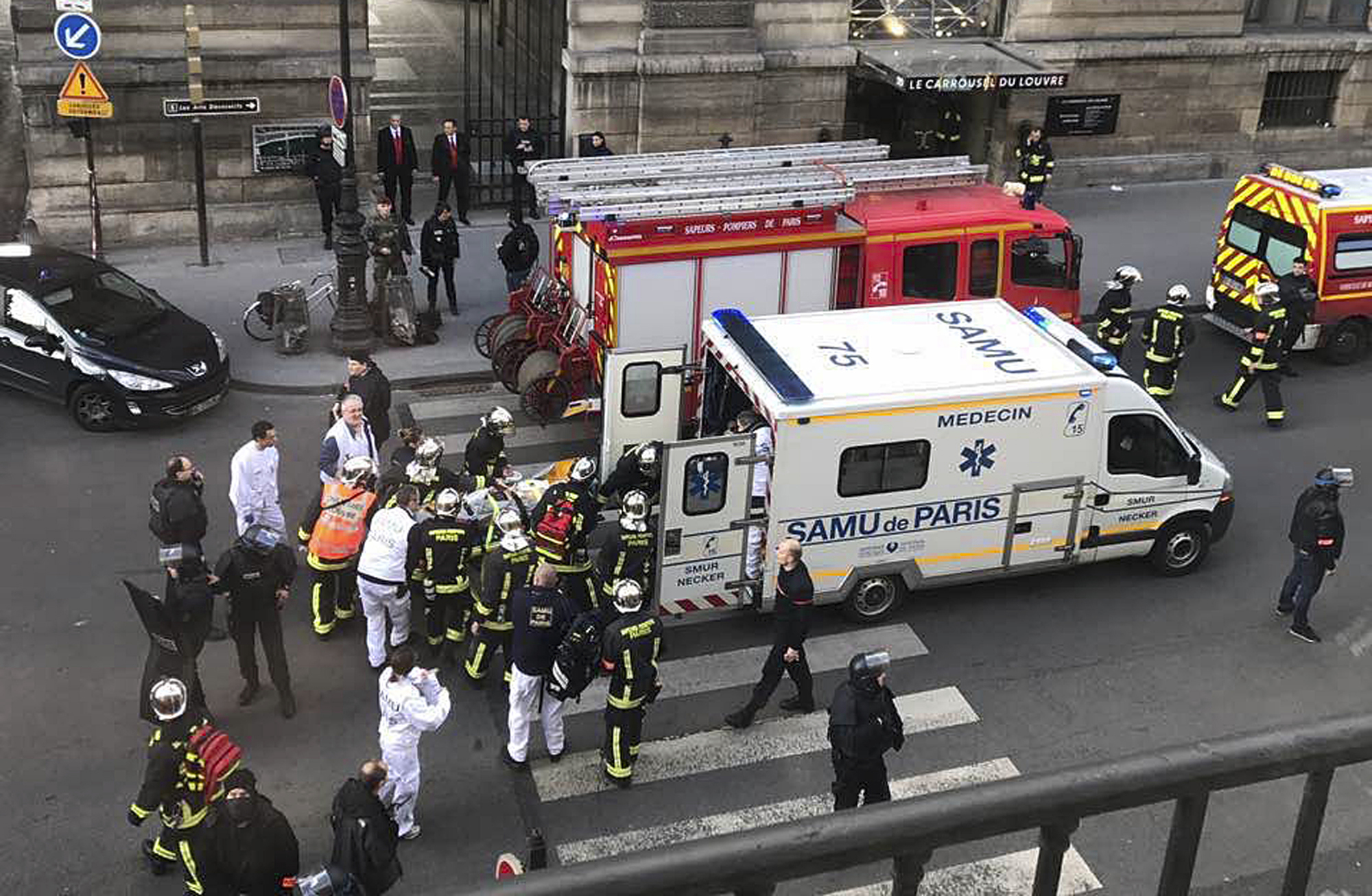 PHOTO: In this photo provided by Sheng Zihao, an unidentified wounded person is taken into an ambulance in Paris, Feb. 3, 2017. 