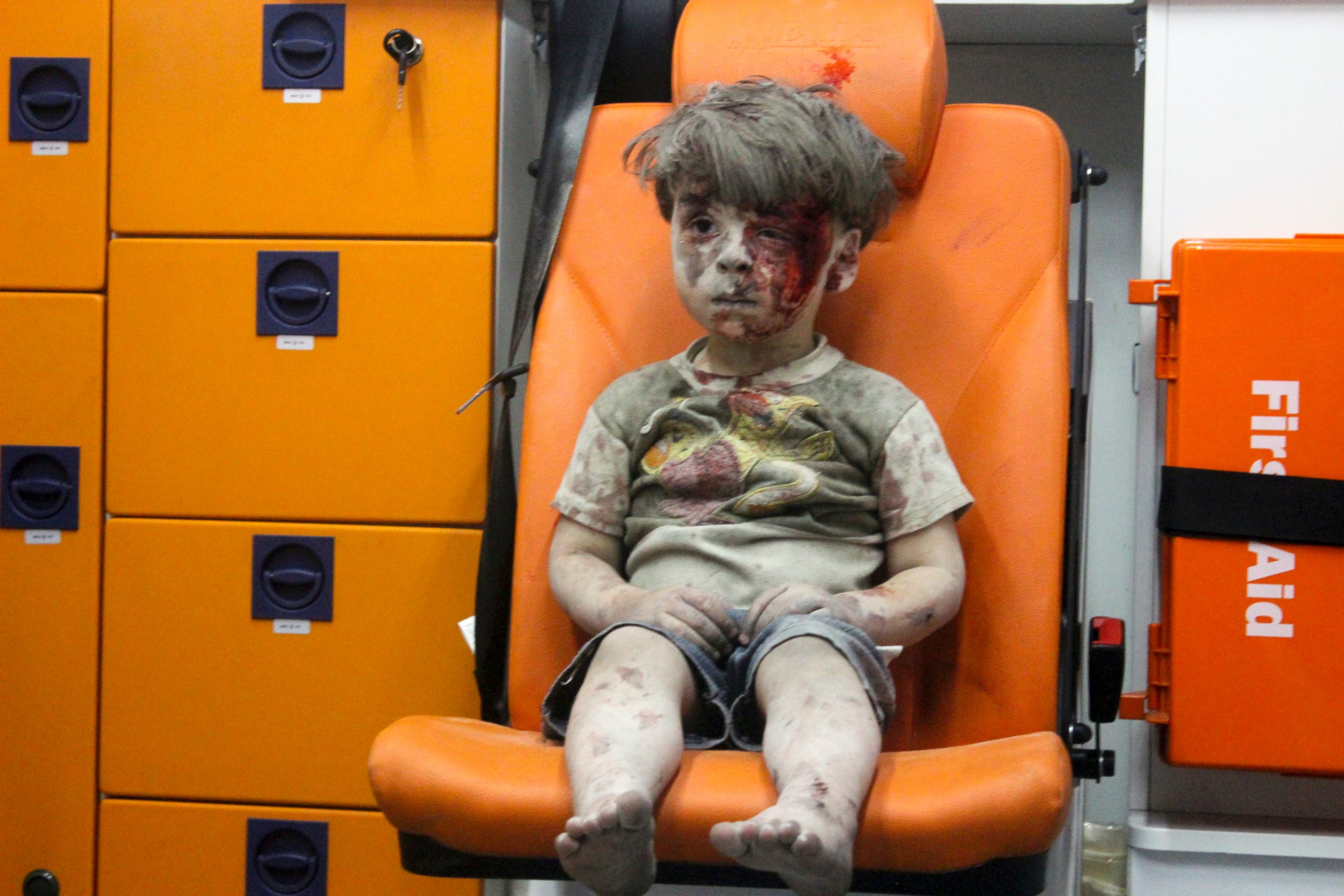 PHOTO: Omran, a four-year-old Syrian boy covered in dust and blood, sits in an ambulance after being rescued from the rubble of a building hit by an air strike in the rebel-held Qaterji neighborhood of the northern Syrian city of Aleppo, Aug. 17, 2016. 