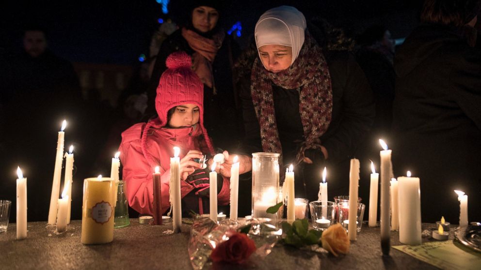 PHOTO: Sawsan Idris, right, lights candles with her daughters Lara and Tamara while attending a vigil in Moncton, New Brunswick, Jan. 30, 2017, for victims of the shooting at a Quebec City mosque. 