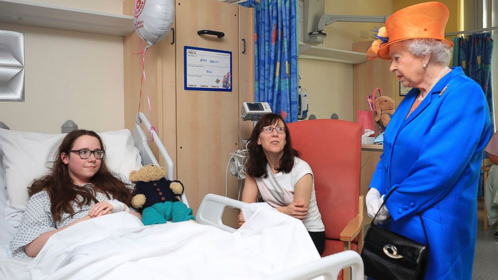 Britain's Queen Elizabeth II, speaks to Amy Barlow from Rawtenstall, Lancashire and her mother, Kathy, as she visits the Royal Manchester Children's Hospital in England, to meet victims and to thank members of staff who treated them, May 25, 2017.