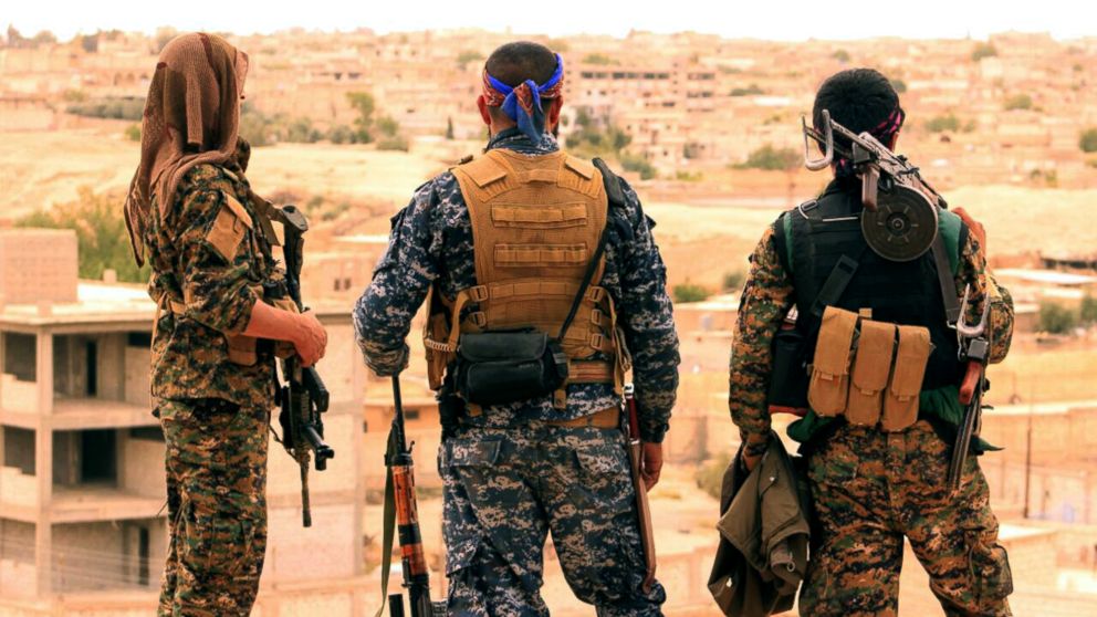PHOTO: Fighters from the SDF look toward the northern town of Tabqa, Syria. 