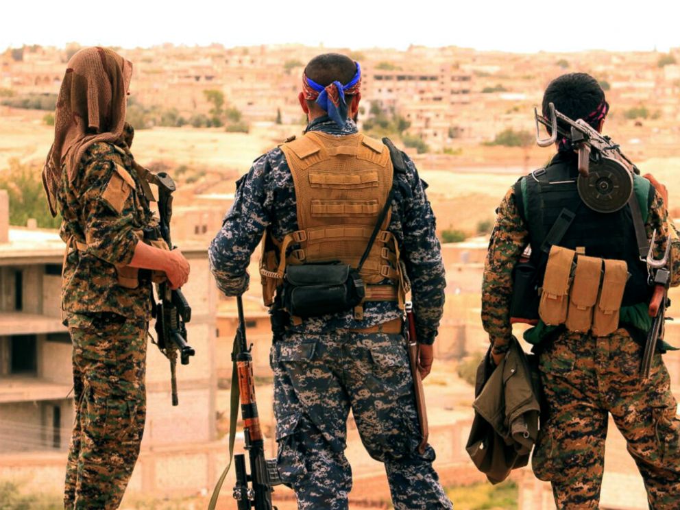 PHOTO: Fighters from the SDF look toward the northern town of Tabqa, Syria.