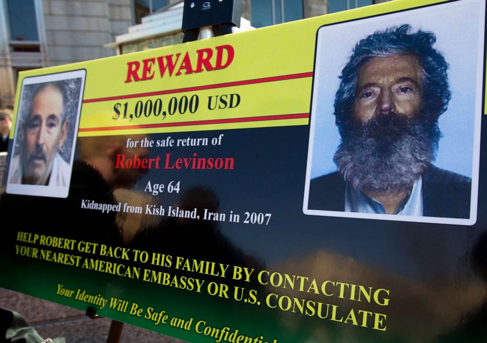 PHOTO: An FBI poster on display March 6, 2012, shows a composite image of former FBI agent Robert Levinson, right, how artists believed he would look after five years in captivity.