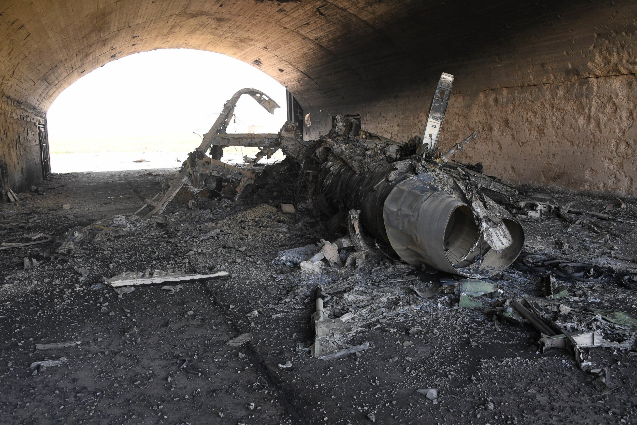 PHOTO: In a photo released by the Russian state-owned news outlet, Sputnik, the body of the remains of a plane burned following the U.S. missile attack on an air base in Syria, April 7, 2017. 