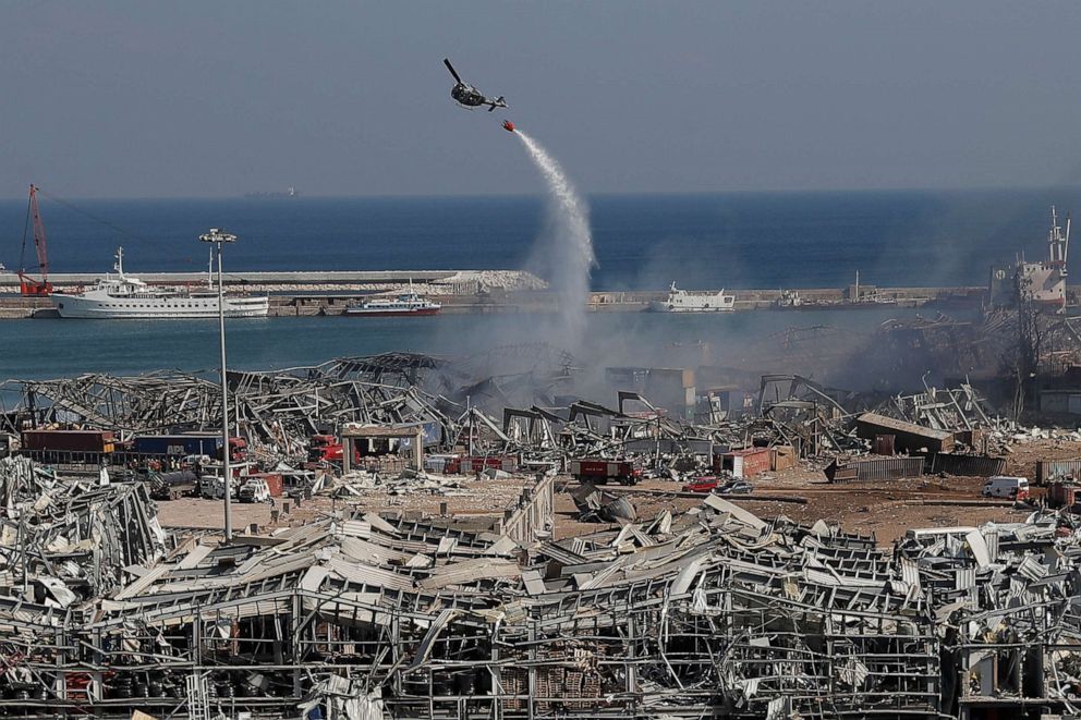 PHOTO: An army helicopter drops water at the scene of Tuesday's massive explosion that hit the seaport of Beirut, Lebanon, Wednesday, Aug. 5, 2020.