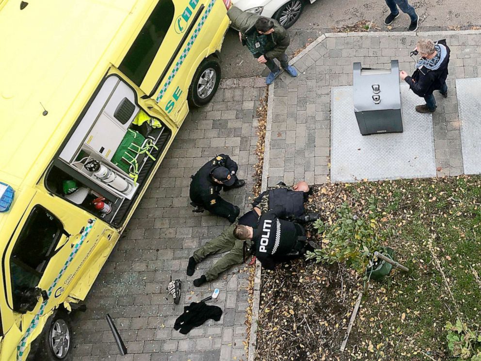 PHOTO: Police detain a man, bottom center laying on the ground, next to a damaged ambulance that he stole after an incident in the center of Oslo, Tuesday, Oct. 22, 2019. (Cathrine Hellesoy, Aftenposten via AP)