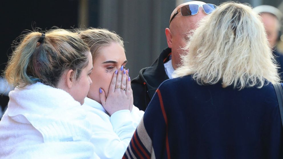 Fan leaves the Park Inn hotel in central Manchester, England, Tuesday, May 23, 2017. Over a dozen people were killed in an explosion following a Ariana Grande concert at the Manchester Arena late Monday evening. (AP Photo/Rui Vieira)