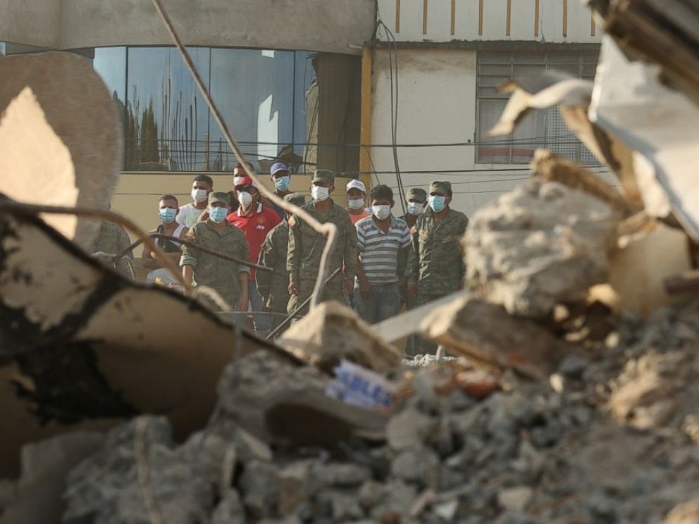 PHOTO: Rescue workers stand behind rubble after an earthquake in Portoviejo, Ecuador, April 17, 2016. Rescuers pulled survivors from the rubble Sunday after the strongest earthquake to hit Ecuador in decades.