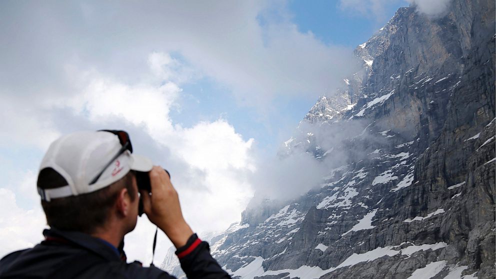 A journalist photographs the Eiger north face during a Media event on the occasion of the 75th anniversary of the first ascent of the Eiger north face above the Kleine Scheidegg, Switzerland, July 11, 2013.