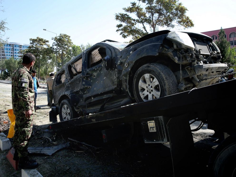 PHOTO: Afghanistan National Army soldiers try to remove a damaged vehicle from the site of a suicide attack near a U.S. military camp in Kabul, Afghanistan, Sept. 16, 2014.