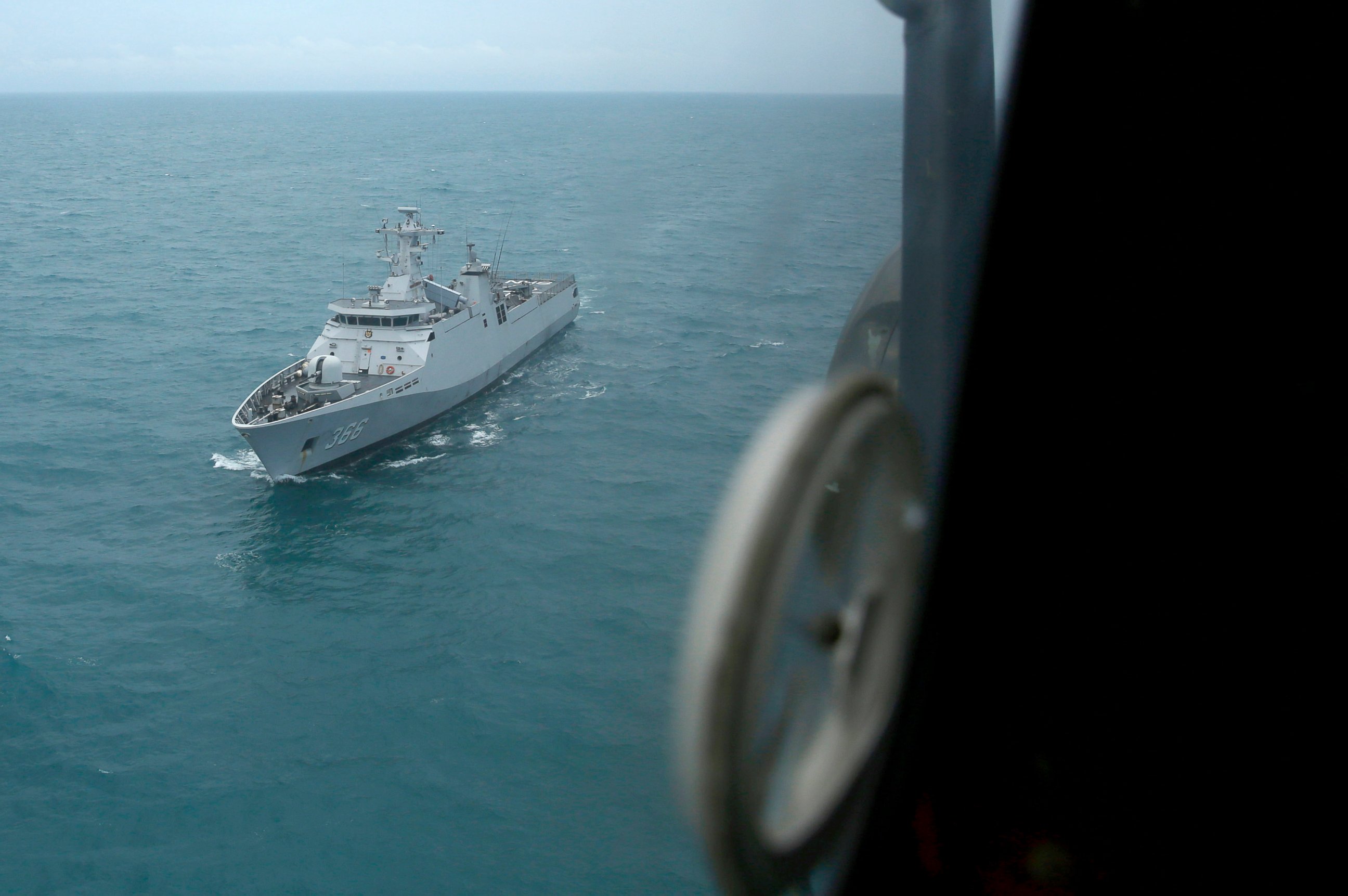 PHOTO: Indonesian Navy ship KRI Sultan Hasanuddin is seen through the window of Air Force Super Puma helicopter during a search operation for the victims of AirAsia Flight 8501 on the Java Sea, Indonesia, Jan. 7, 2015.