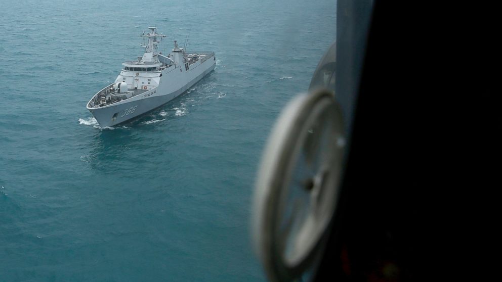 PHOTO: Indonesian Navy ship KRI Sultan Hasanuddin is seen through the window of Air Force Super Puma helicopter during a search operation for the victims of AirAsia Flight 8501 on the Java Sea, Indonesia, Jan. 7, 2015.